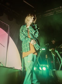 a man standing on stage with a microphone