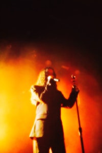 a man in a suit singing into a microphone