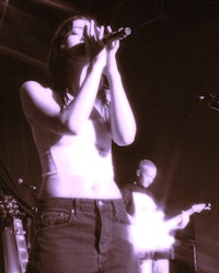 a woman singing into a microphone