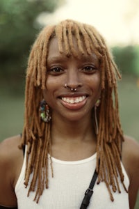 a woman with dreadlocks smiling